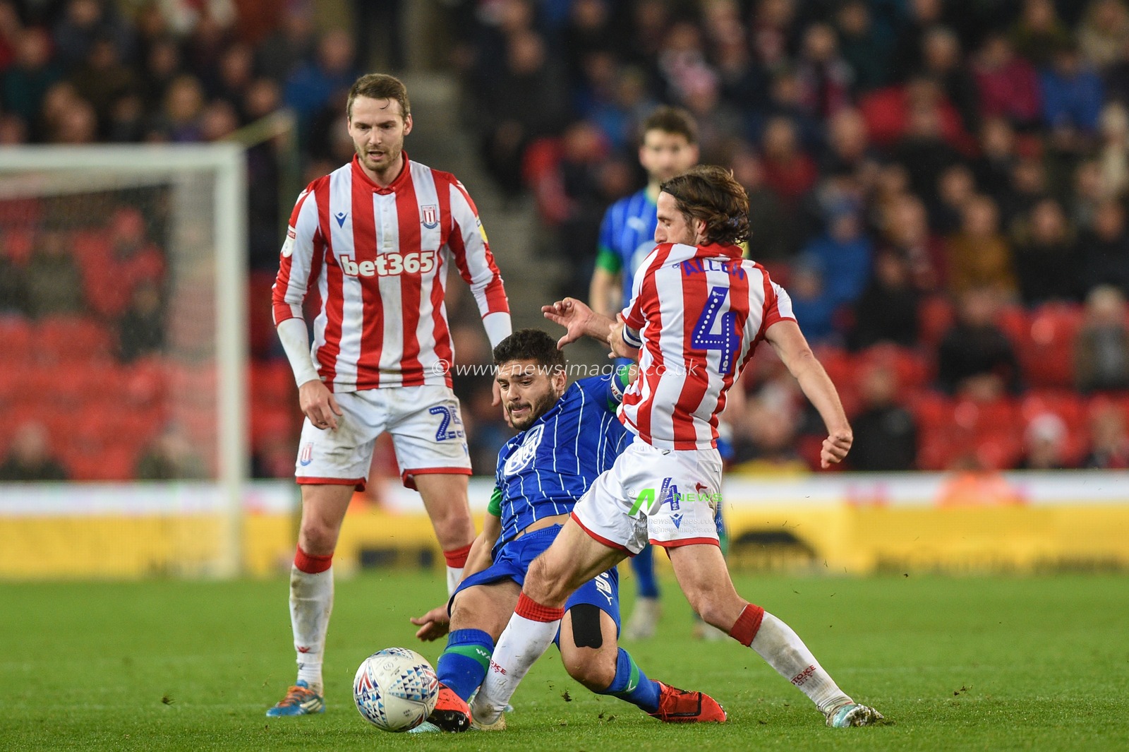 23rd November 2019, Bet365 Stadium, Stoke-on-Trent, England; Sky Bet Championship, Stoke City v Wigan Athletic : Sam Morsy (5) of Wigan Athletic is brought down by Joe Allen (4) of Stoke City 

Credit: Richard Long/News Images