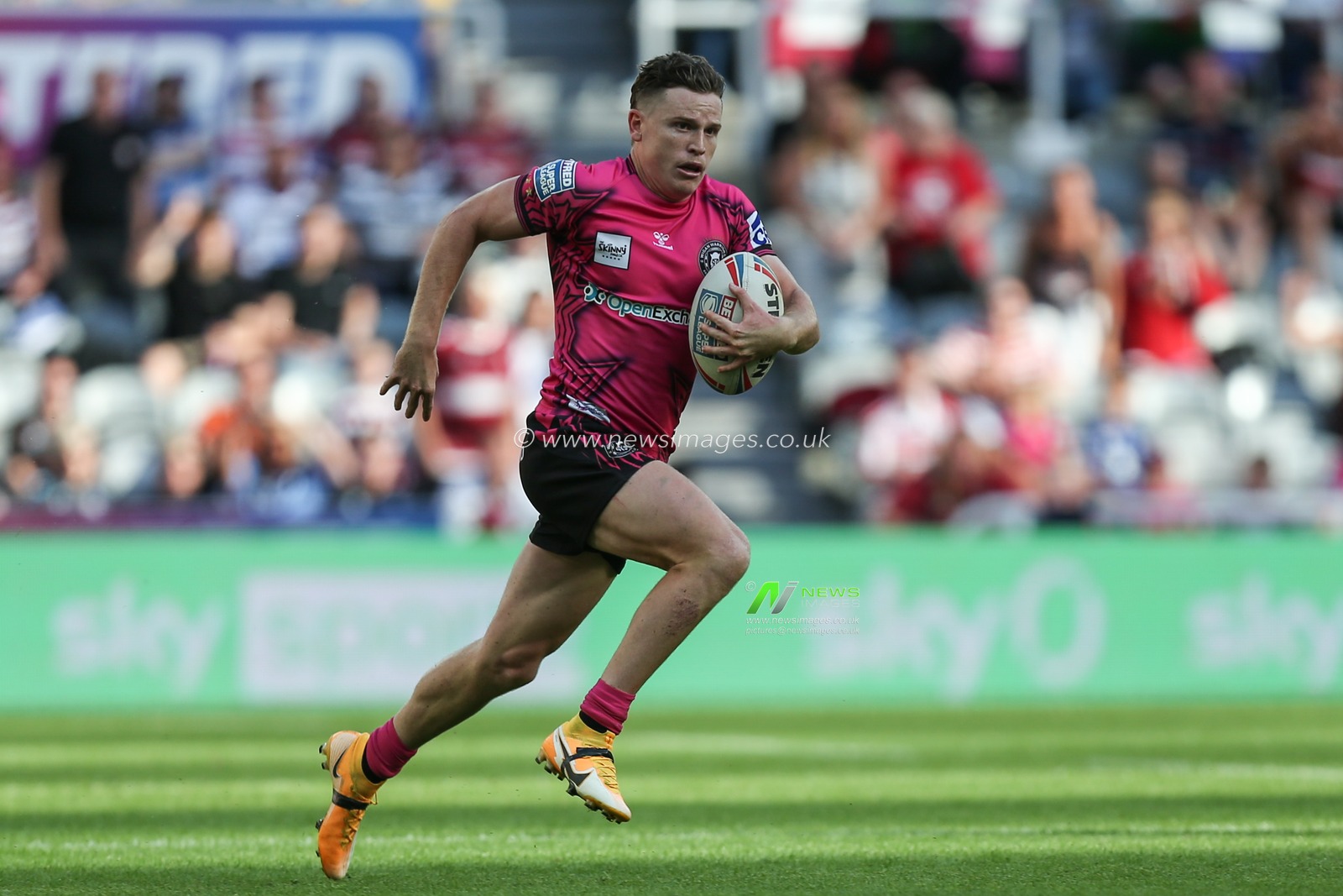 Jai Field #23 of Wigan Warriors runs with the ball