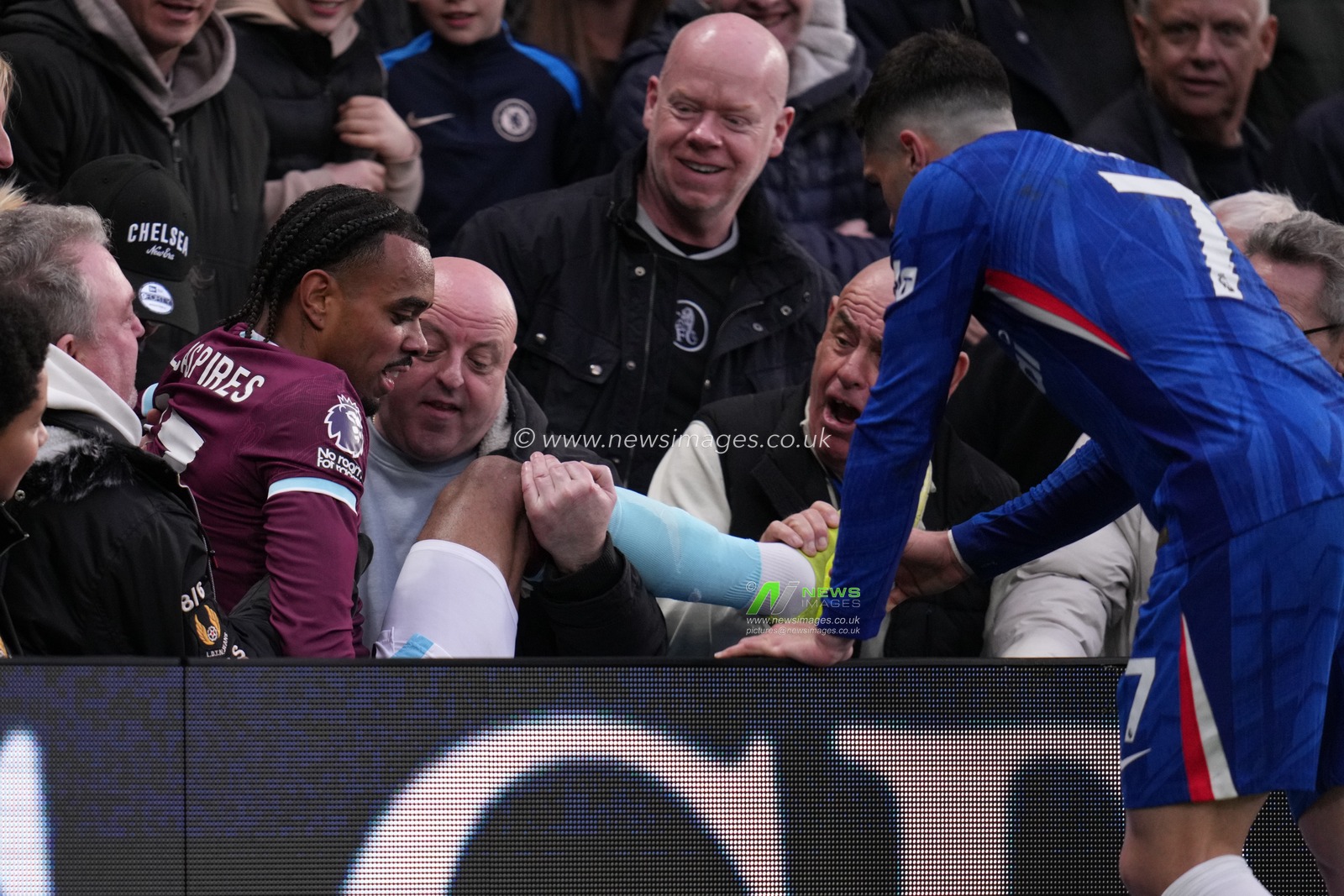 Pedro Neto of Chelsea helps Lucas Pires of Burnley after falling into crowd during the Premier League match Chelsea vs Burnley at Stamford Bridge, London, United Kingdom on 21 February 2026

(Photo by Harvey Murphy/News Images)