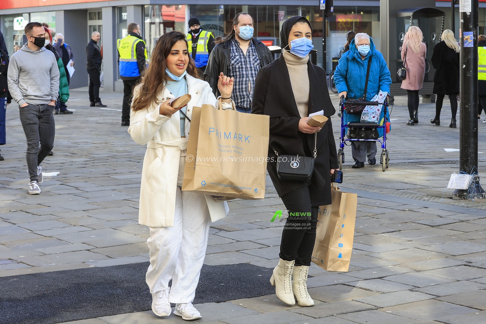Two people with Primark shopping bags in Northumberland Street, Newcastle upon Tyne, as retail premises are allowed to reopen to the public as national lockdown restrictions are eased