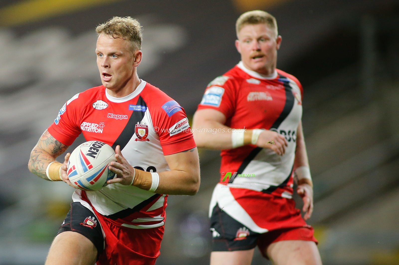 Kevin Brown (7) of Salford Red Devils on the attack against Castleford Tigers.
