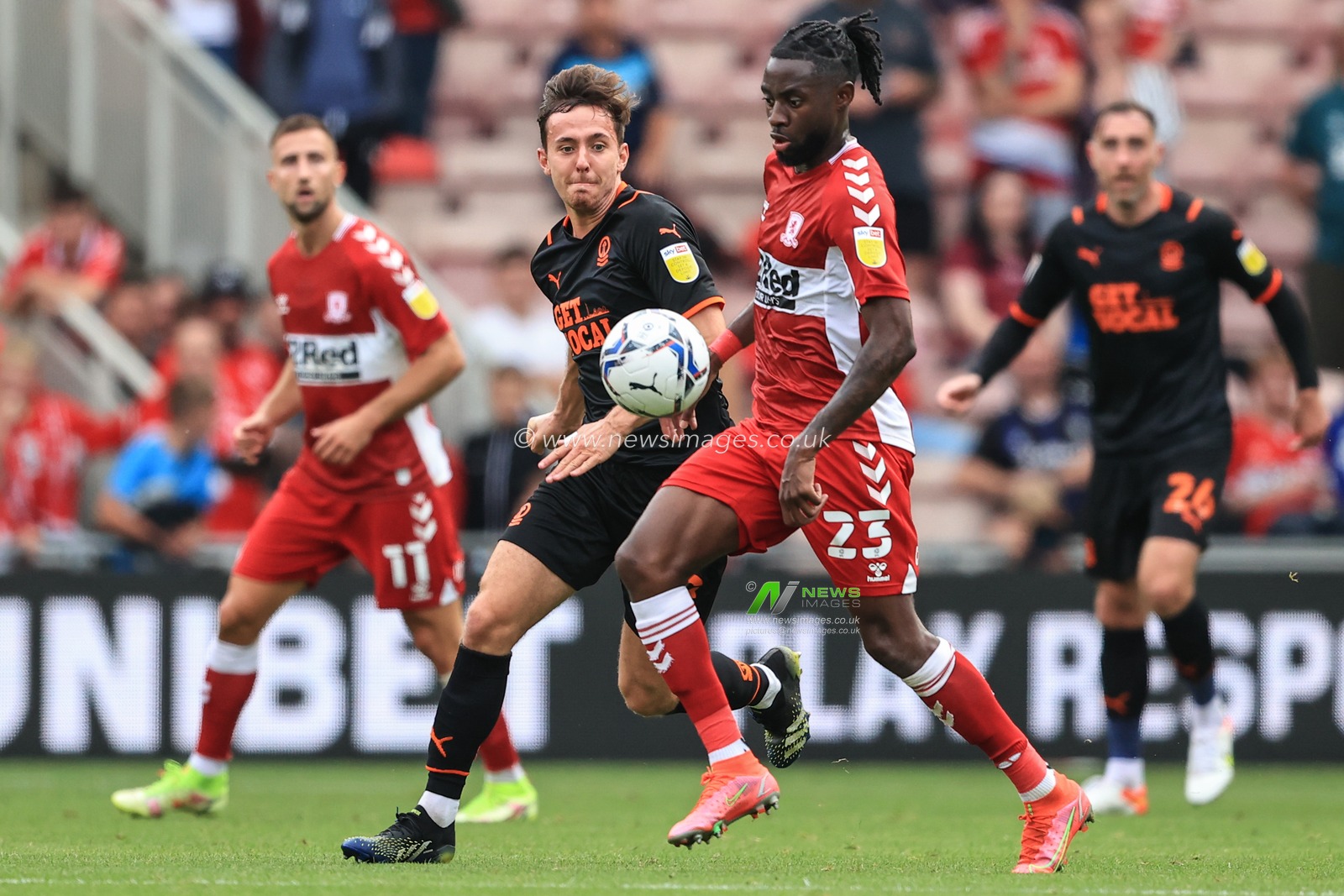 James Lea Siliki #23 of Middlesbrough holds the ball as Ryan Wintle #8 of Blackpool pressures