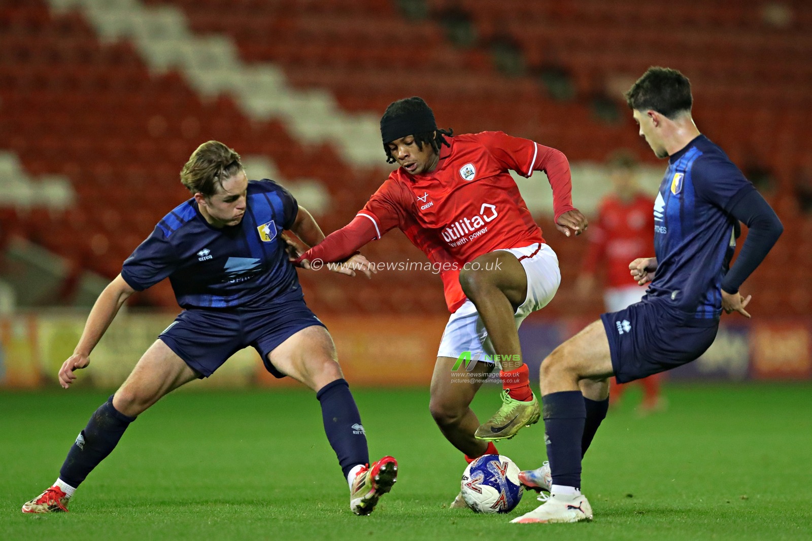 Harley Mott of Mansfield Town U18's and Mace Oldershaw of Mansfield Town U18's pressure Feyi Afuape of Barnsley FC U18's during the FA Youth Cup U18’s round 2 match Barnsley vs Mansfield Town at Oakwell, Barnsley, United Kingdom, 17th November 2025(Photo by Sam Eaden/News Images)