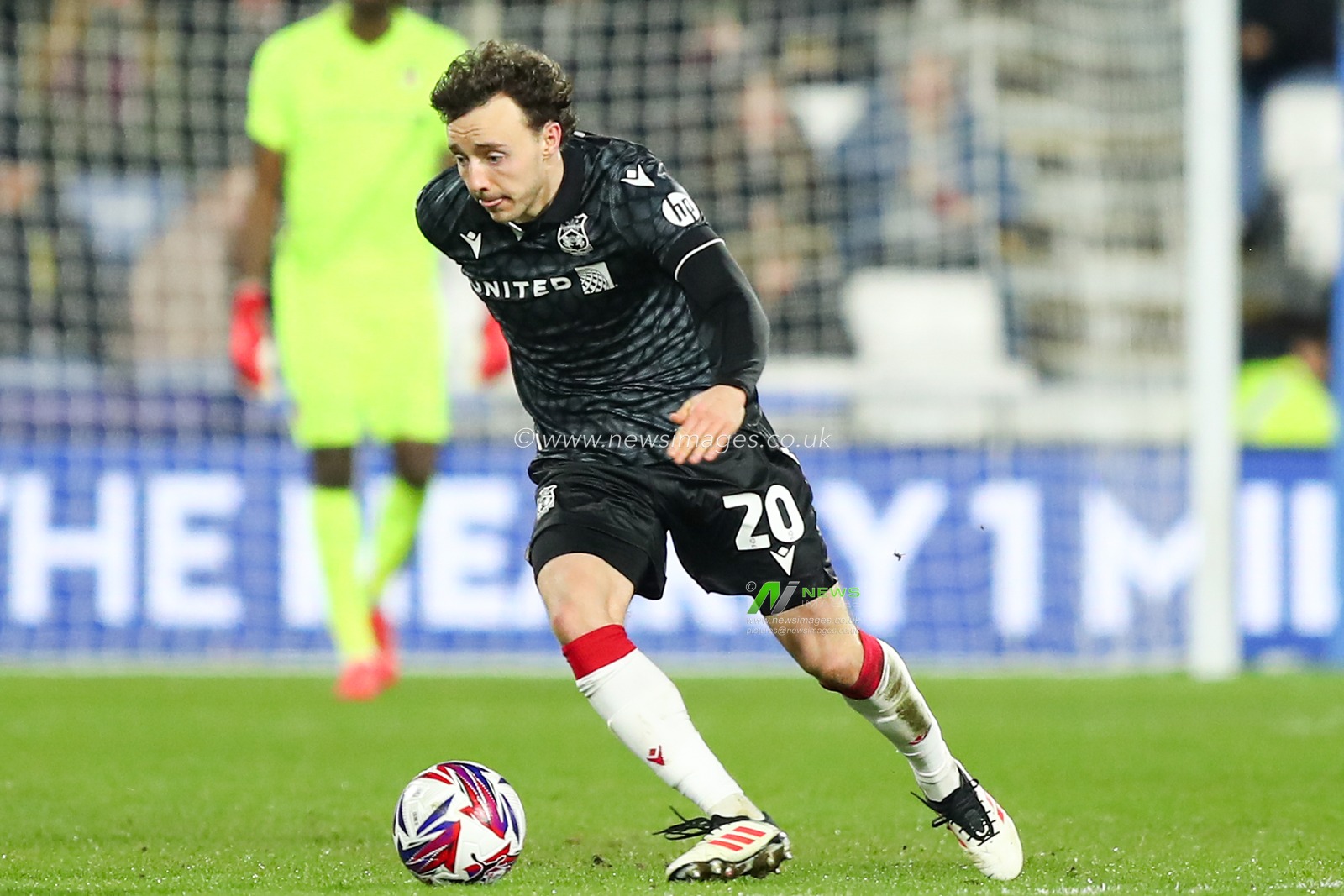 Ollie Rathbone of Wrexham with the ball at his feet during the Sky Bet League 1 match Huddersfield Town vs Wrexham at John Smith's Stadium, Huddersfield, United Kingdom, 4th March 2025

(Photo by Jorge Horsted/News Images)