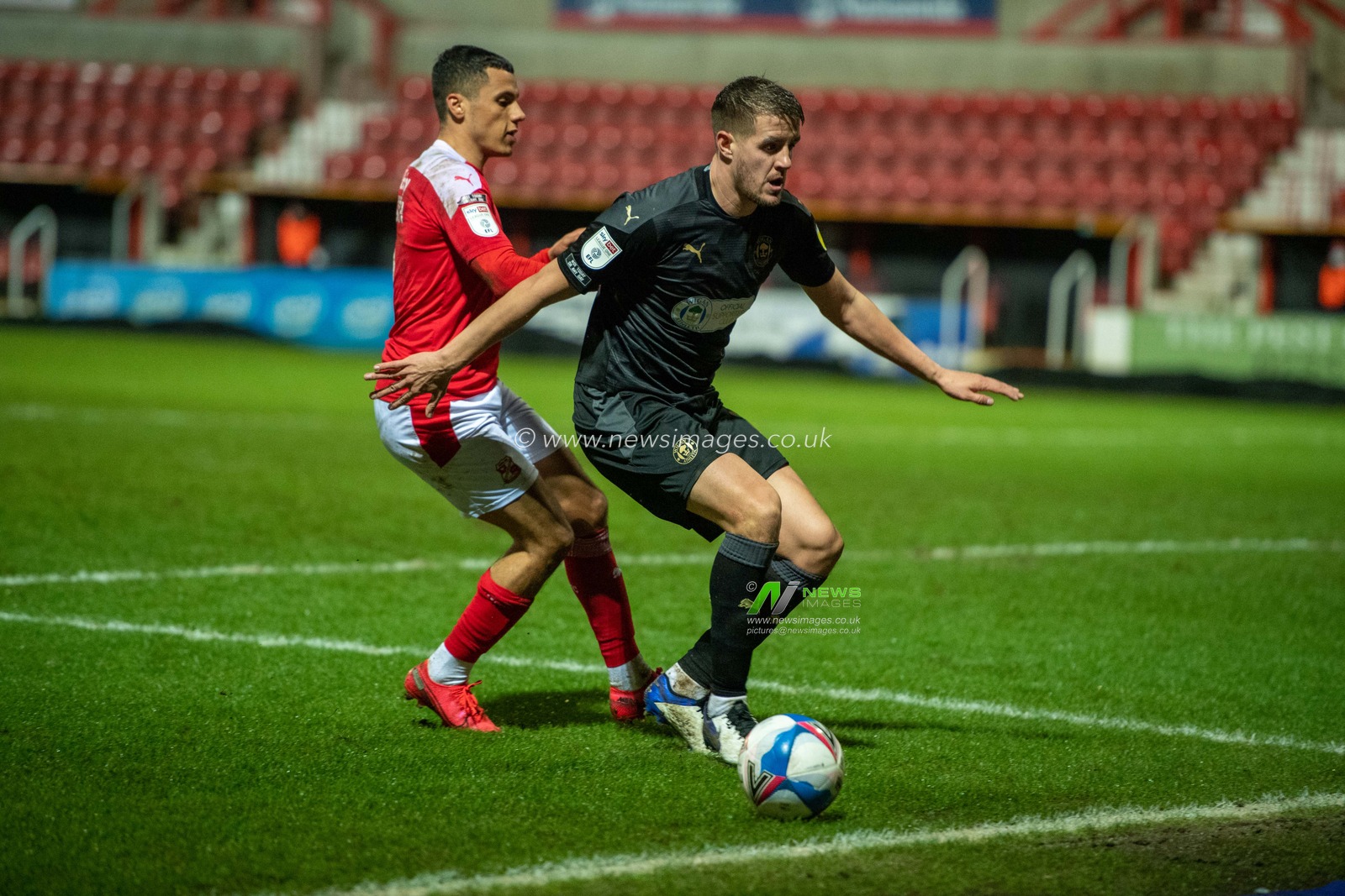 Scott Wootton #14 of Wigan Athletic tidies up at the back for Wigan Athletic
