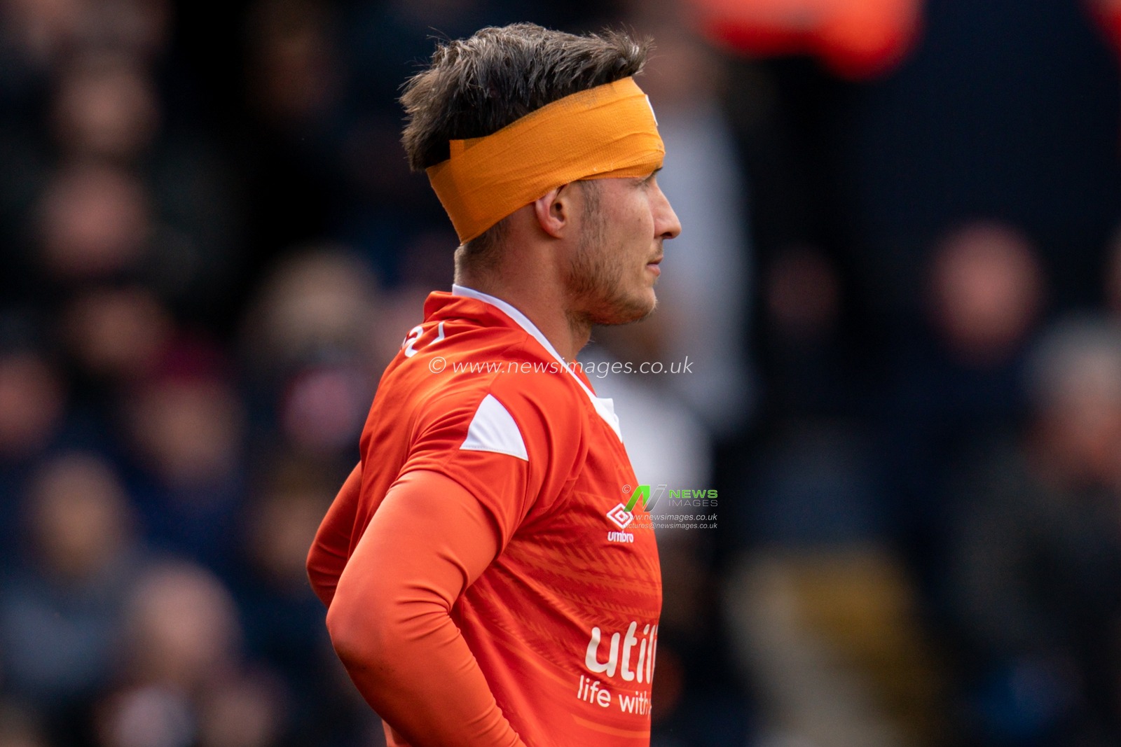 Dan Potts #3 of Luton Town after receiving medical attention for a facial wound