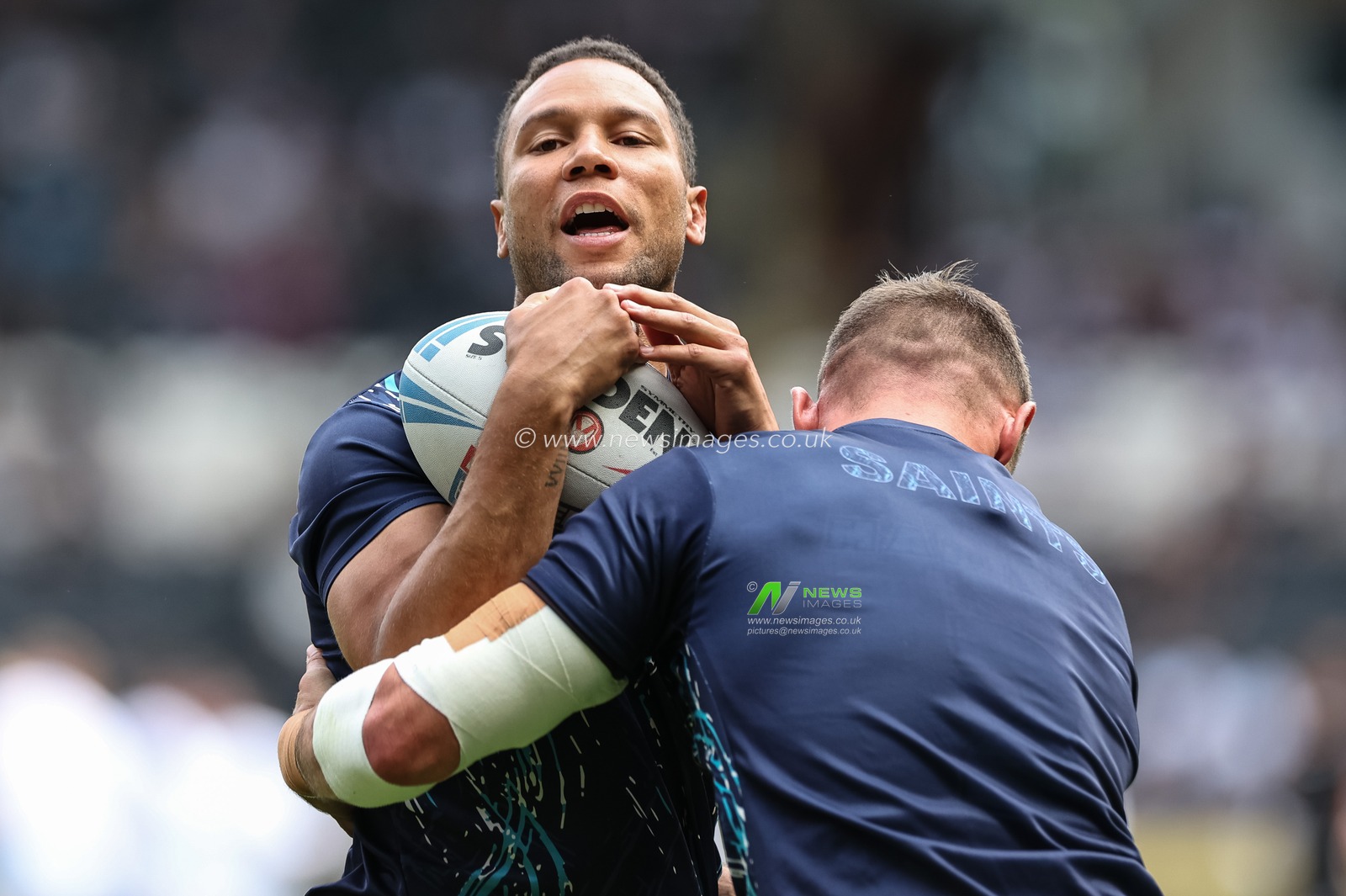 Moses Mbye of St. Helens and Tommy Makinson of St. Helens in the pre-game warm up during the Betfred Super League Round 20 match Hull FC vs St Helens at MKM Stadium, Hull, United Kingdom, 3rd August 2024

(Photo by Mark Cosgrove/News Images)