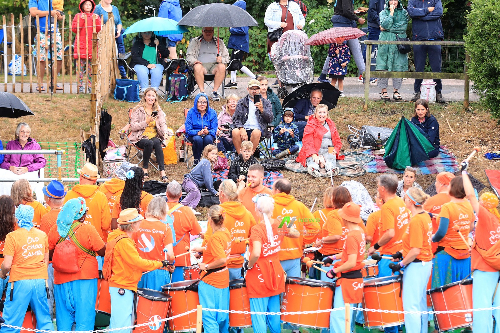 The crowd acknowledge the music from the Old School Samba float as it passes by.