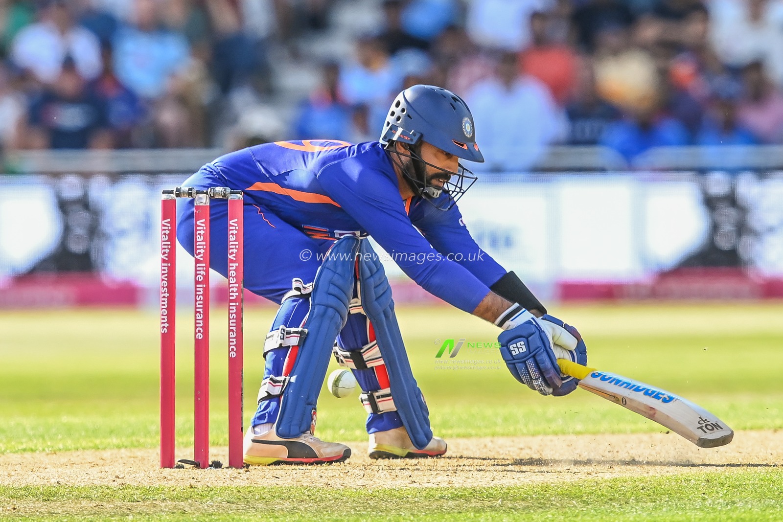 Dinesh Karthik of India misjudges the ball