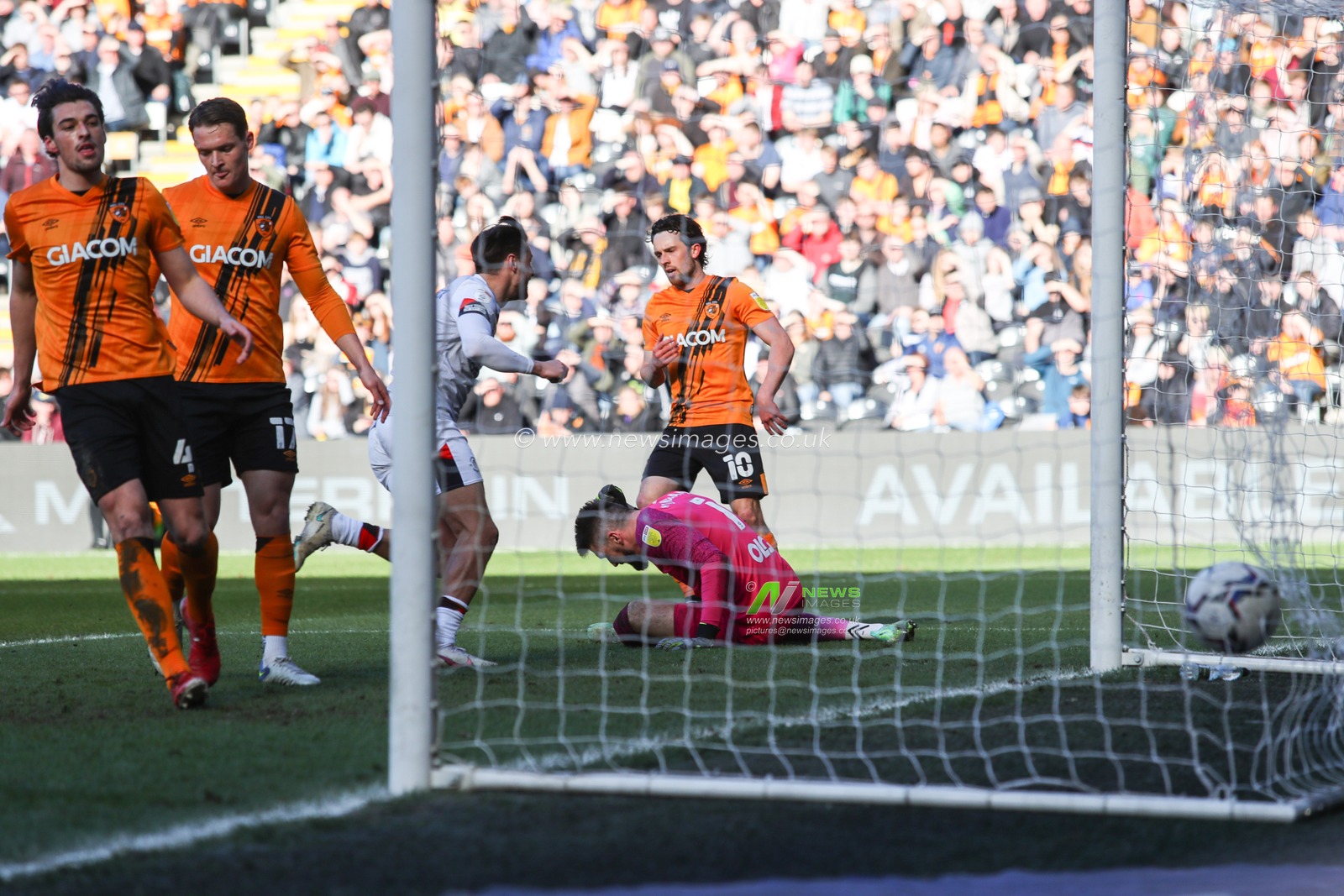 Matt Ingram #1 of Hull City on the floor after Elijah Adebayo #11 of Luton Town scores to make it 0-1
