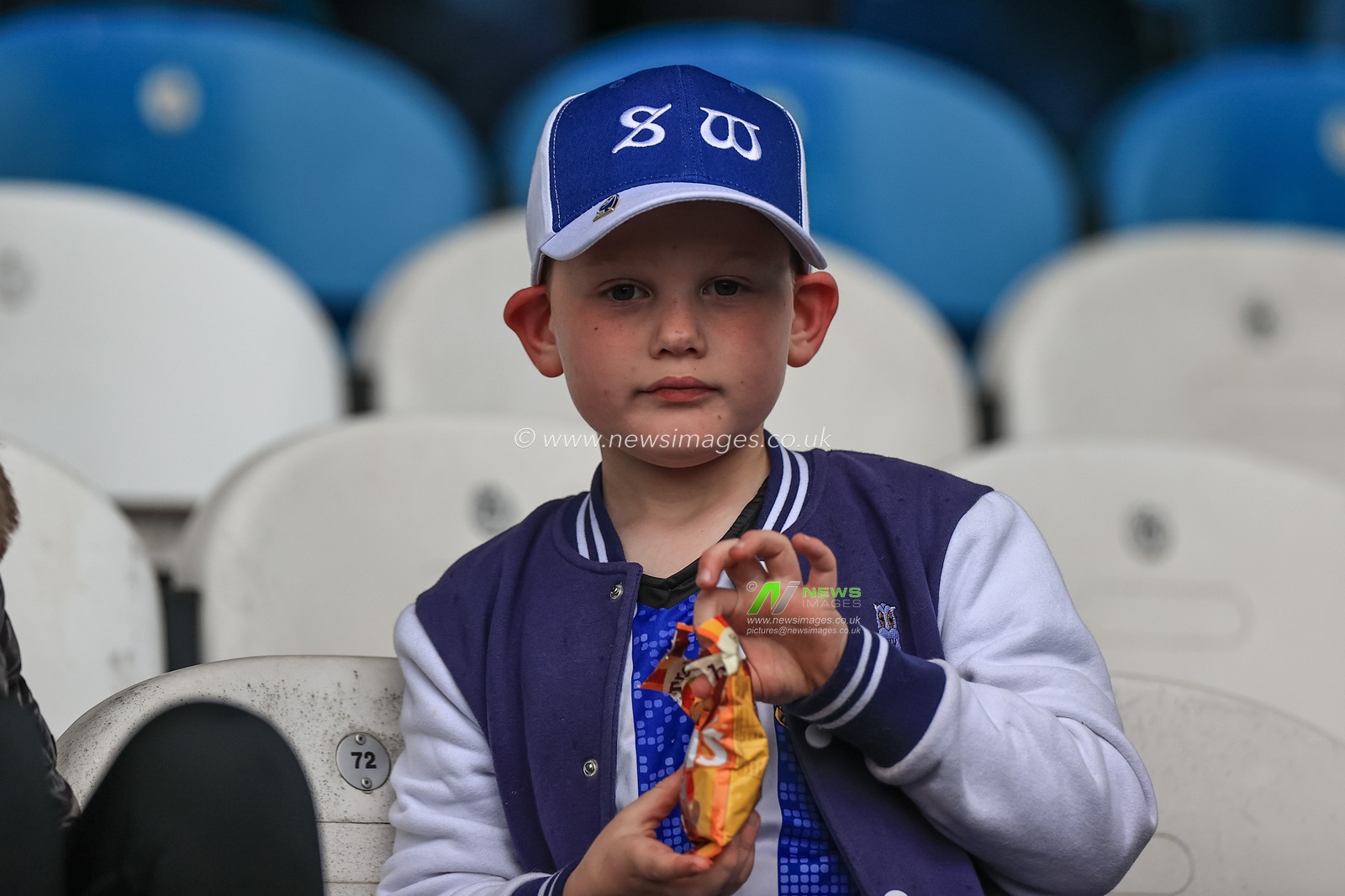 A young Sheffield Wednesday fan opens a bag of sweets