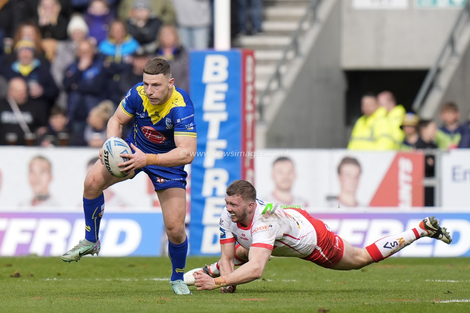 George Williams of Warrington Wolves breaks a tackle from Joe Batchelor of St. Helens during the Betfred Challenge Cup Quarter Final match St Helens vs Warrington Wolves at Totally Wicked Stadium, St Helens, United Kingdom, 14th April 2024

(Photo by Steve Flynn/News Images)