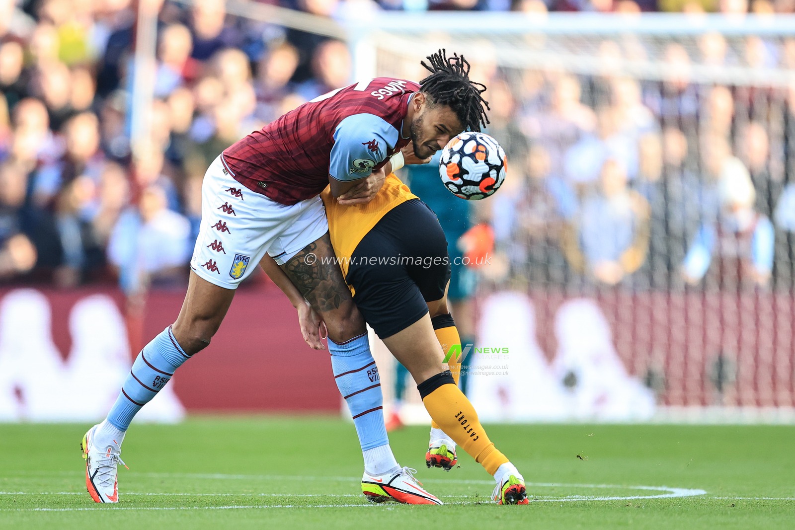 Tyrone Mings #5 of Aston Villa wins the ball from Hwang Hee-chan #26 of Wolverhampton Wanderers