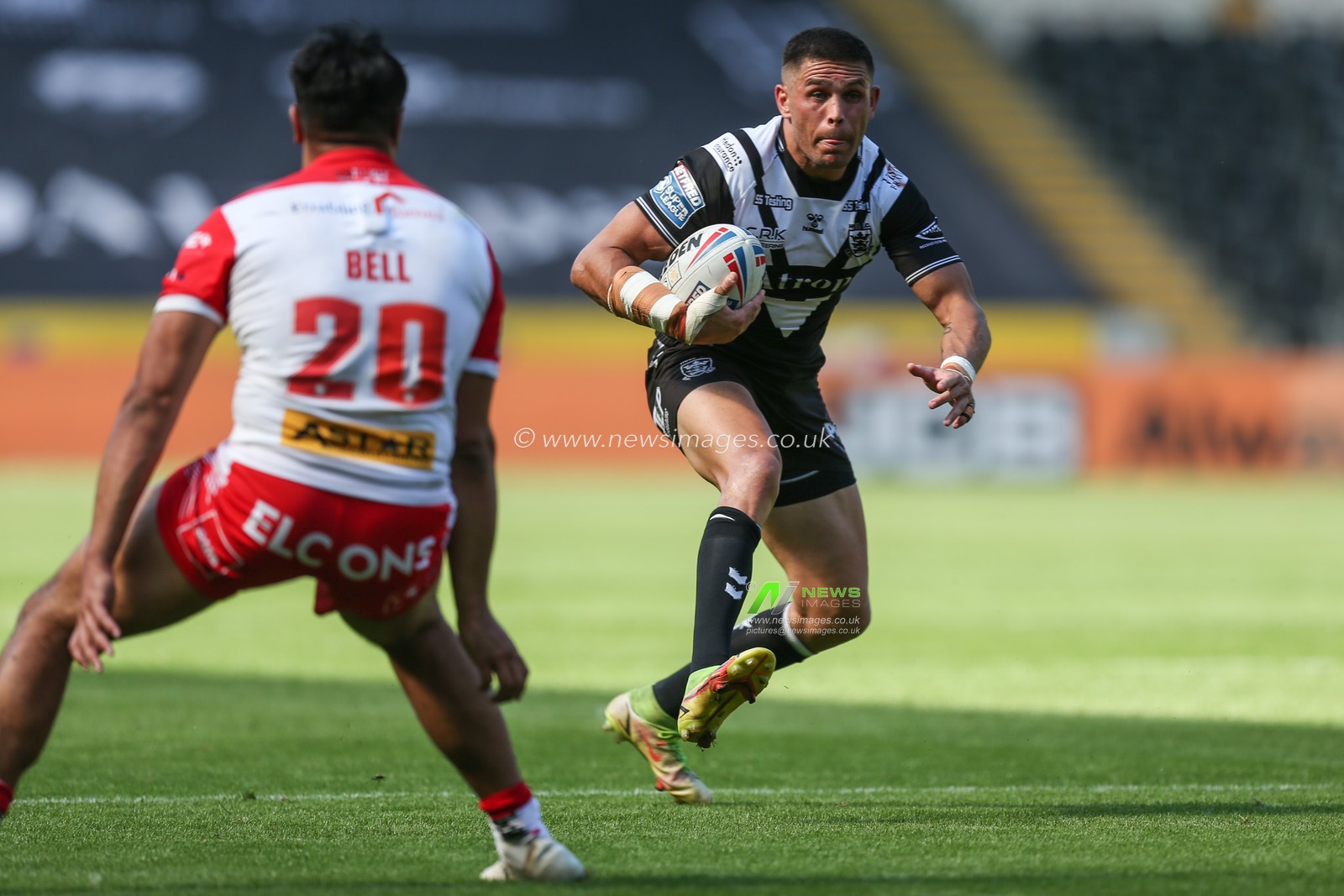 Will Smith #40 of Hull FC looks to go past James Bell #20 of St Helens