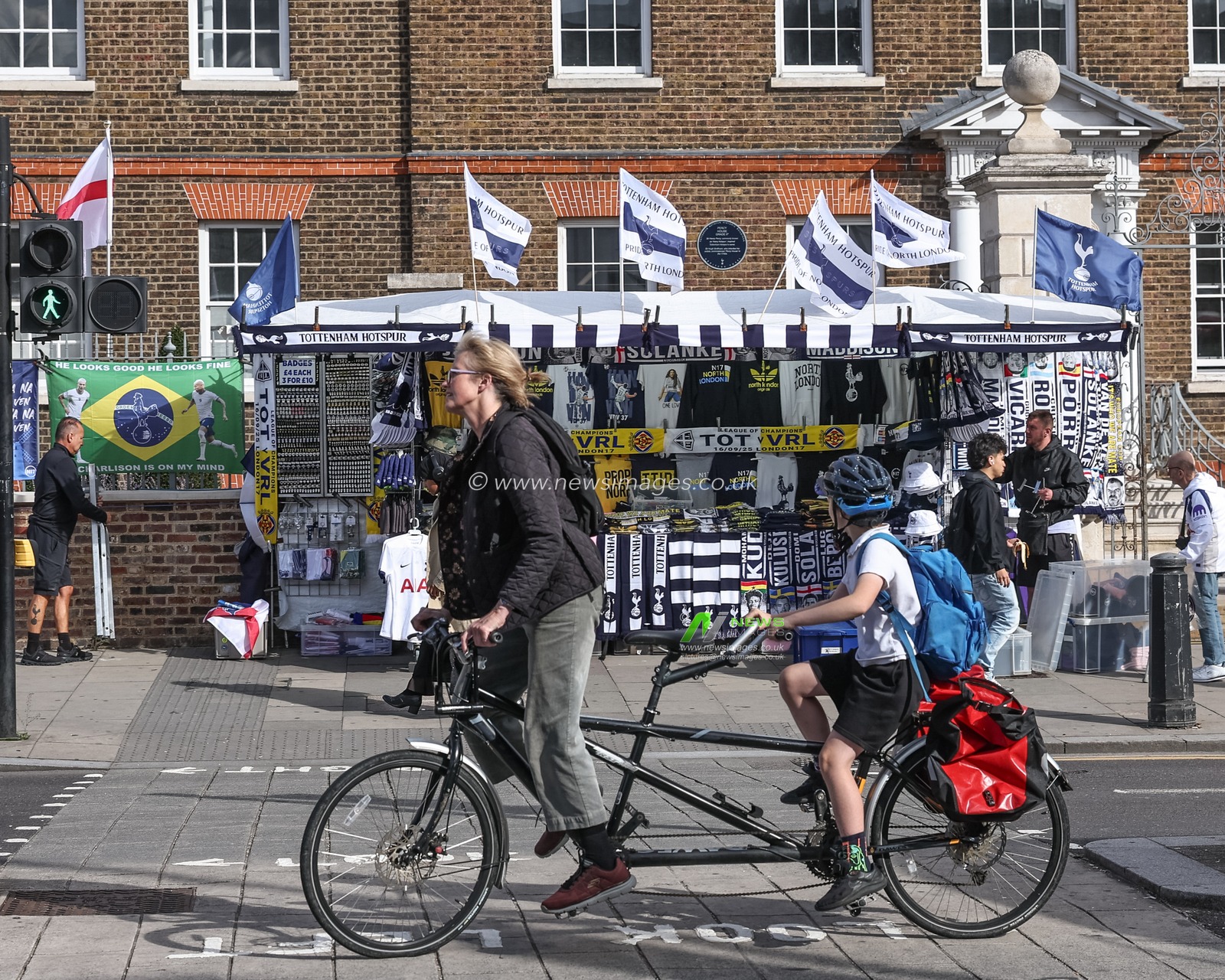 Two locals ride past a memorabilia stall on a tandem during the UEFA Champions League League Stage match Tottenham Hotspur vs Villarreal at Tottenham Hotspur Stadium, London, United Kingdom, 16th September 2025

(Photo by Mark Cosgrove/News Images)
