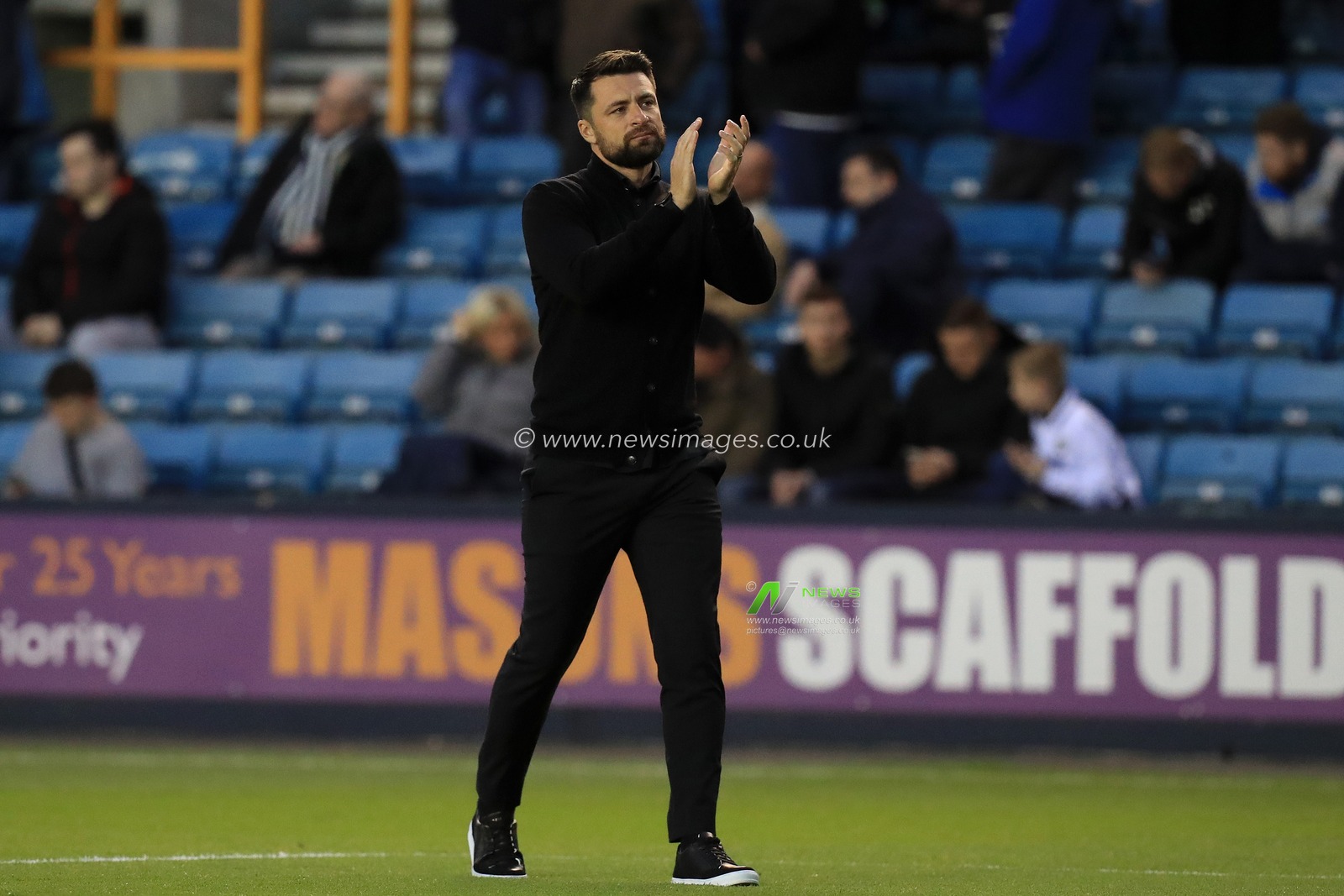 Russell Martin manager of Swansea City applauds the travelling support.