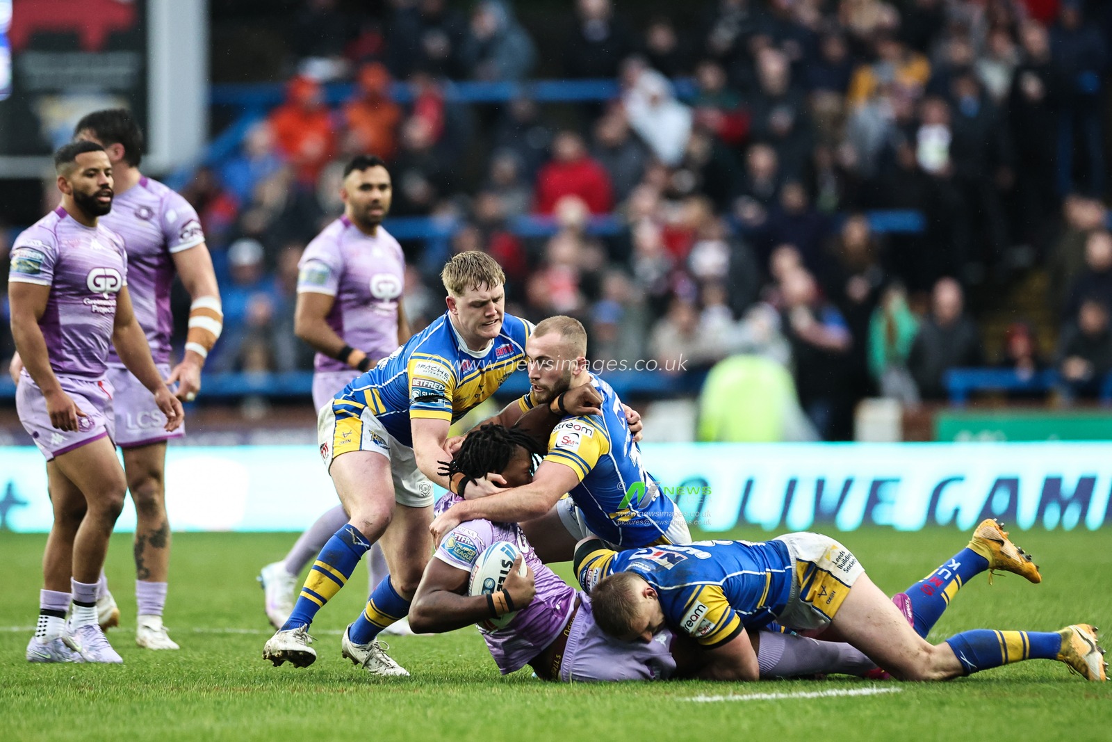 Junior Nsemba of Wigan Warriors is tackled during the Betfred Super League Round 5 match Leeds Rhinos vs Wigan Warriors at Headingley Stadium, Leeds, United Kingdom, 22nd March 2025

(Photo by Mark Cosgrove/News Images)