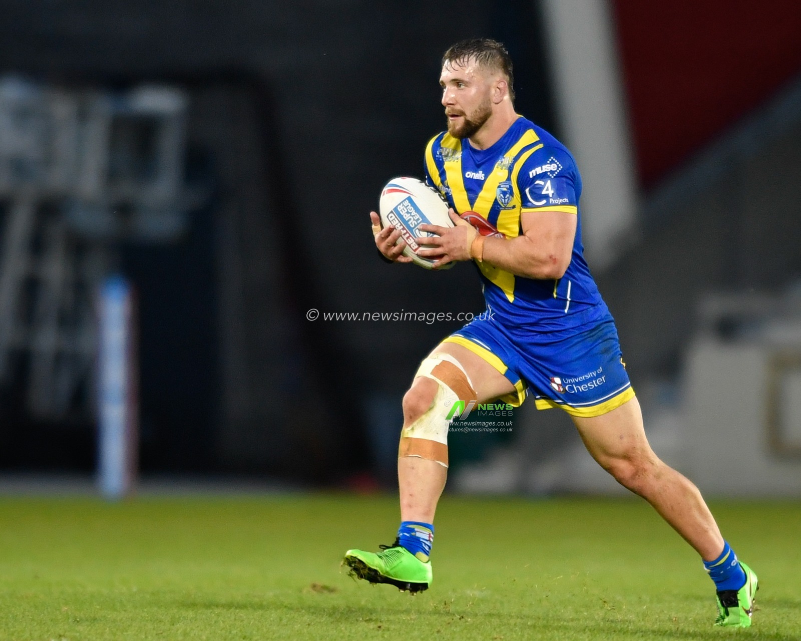 Matt Davis (19) of Warrington Wolves runs forward with the ball