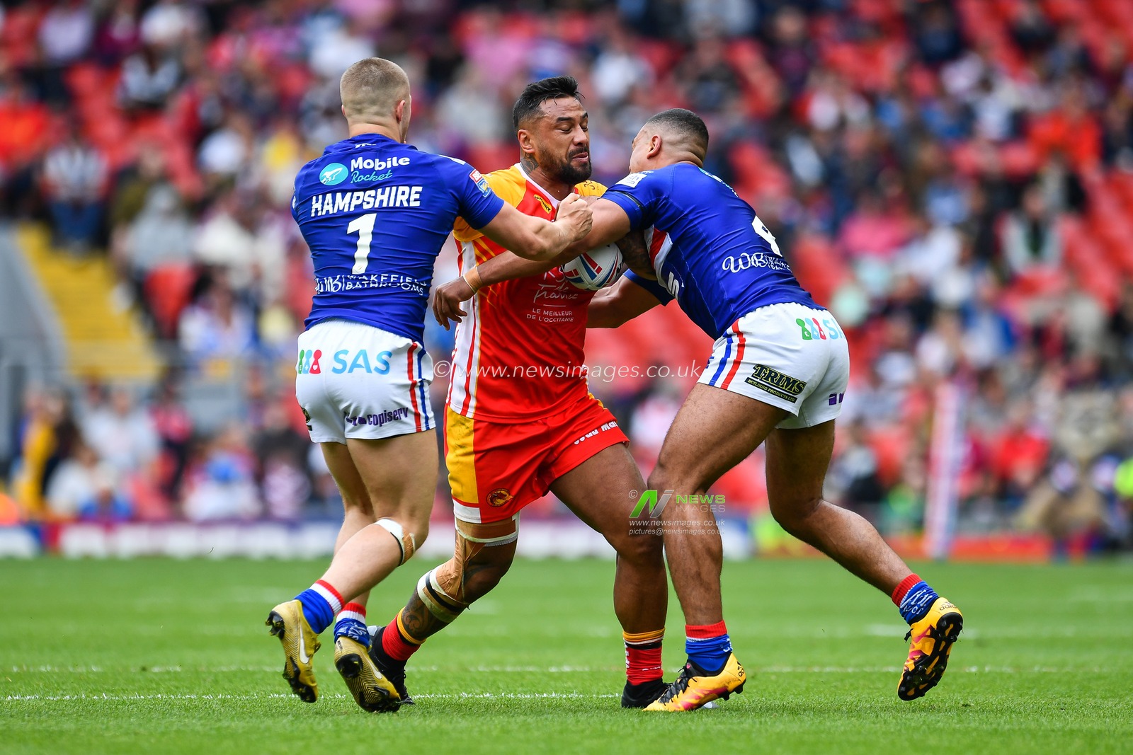 25th May 2019 , Anfield Stadium, Liverpool, England; Dacia Magic Weekend, Betfred Super League Round 16, Wakefield Trinity vs Catalans Dragons ; Kenny Edwards (11) of Catalans Dragons is tackled by Reece Lyne (4) of Wakefield Trinity 

Credit: Craig Thomas/News Images