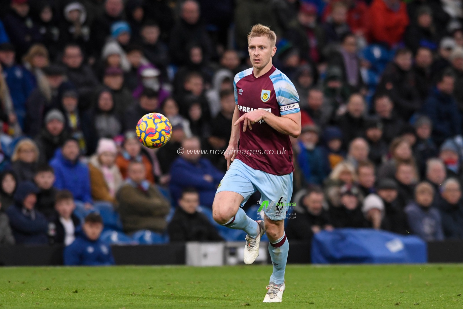 Ben Mee #6 of Burnley runs with the ball