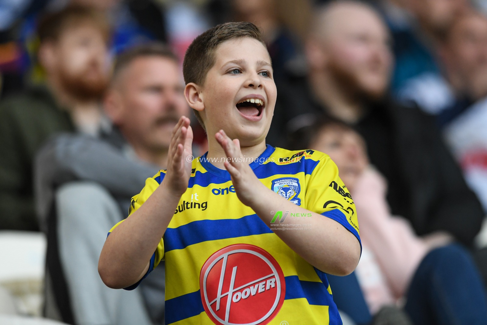 A young Warrington Wolves fan cheers on his team