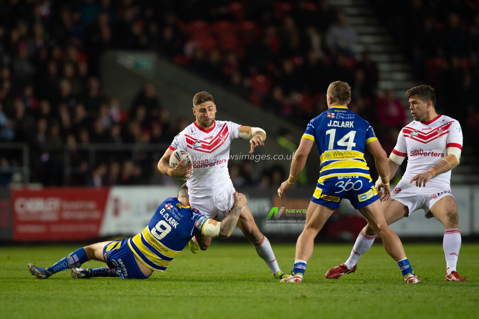 12th April 2019 , Totally Wicked Stadium, St Helens, England;  Betfred Super League, Round 10, St Helens vs Warrington Wolves,  Tommy Makinson of St Helens is tackled by Daryl Clark of Warrington Wolves 

Credit: Richard Long/News Images
