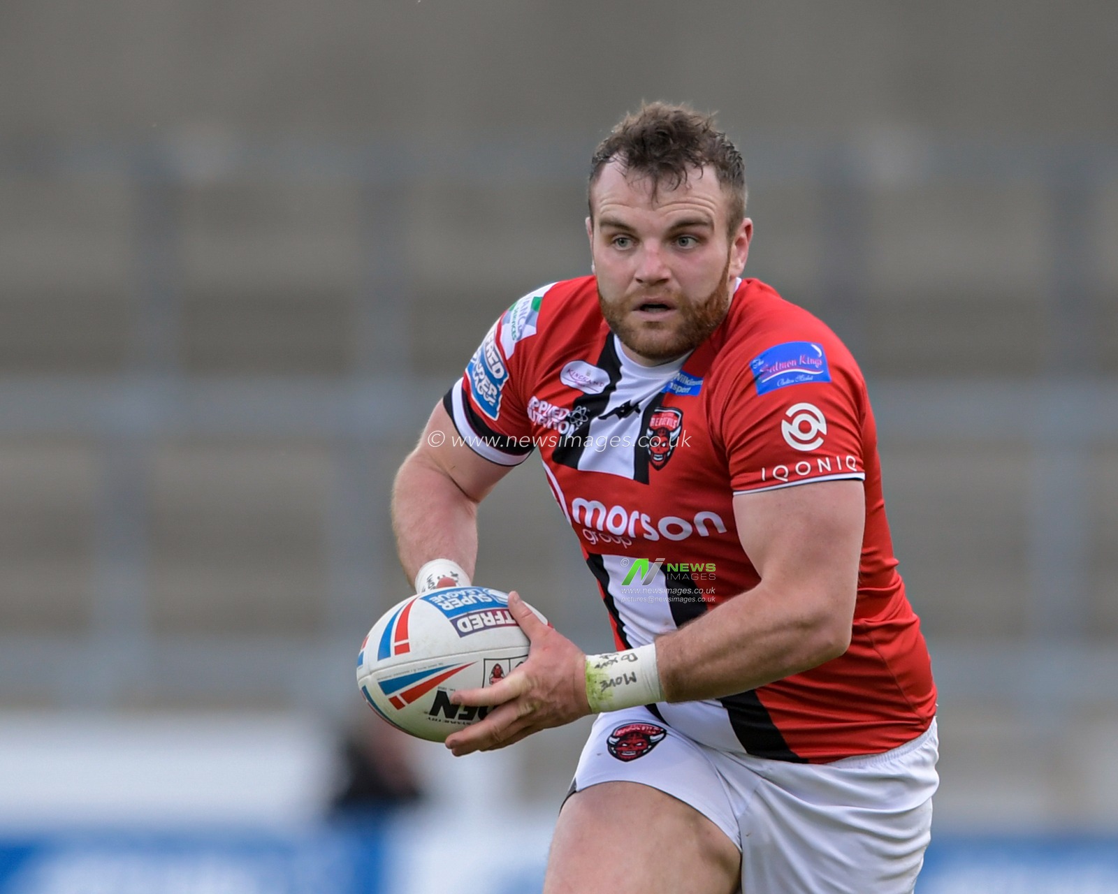 Greg Burke (16) of Salford Red Devils runs forward with the ball