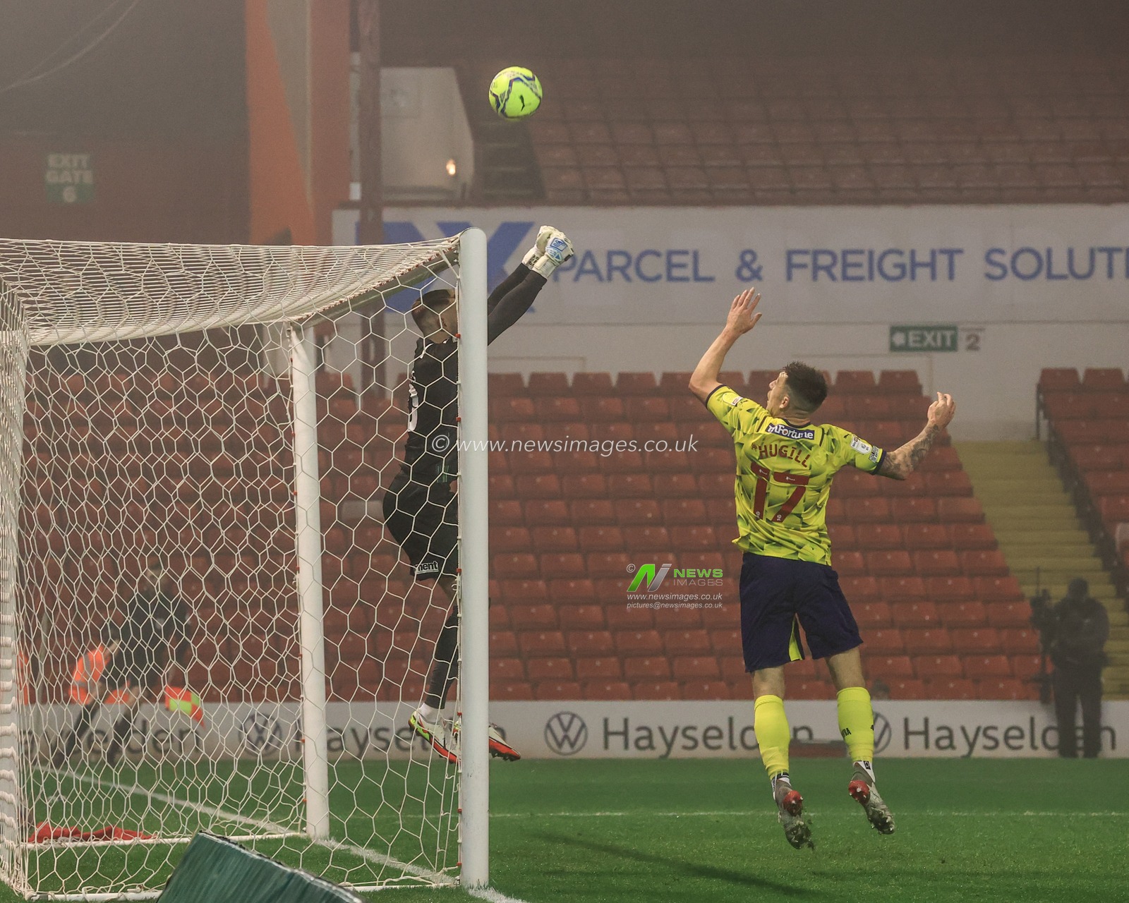 Bradley Collins #40 of Barnsley punches the ball over the bar