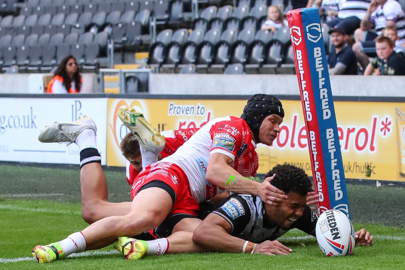 Darnell McIntosh #5 of Hull FC loses the ball and receives an injury while trying to score a try in the final minutes of the match