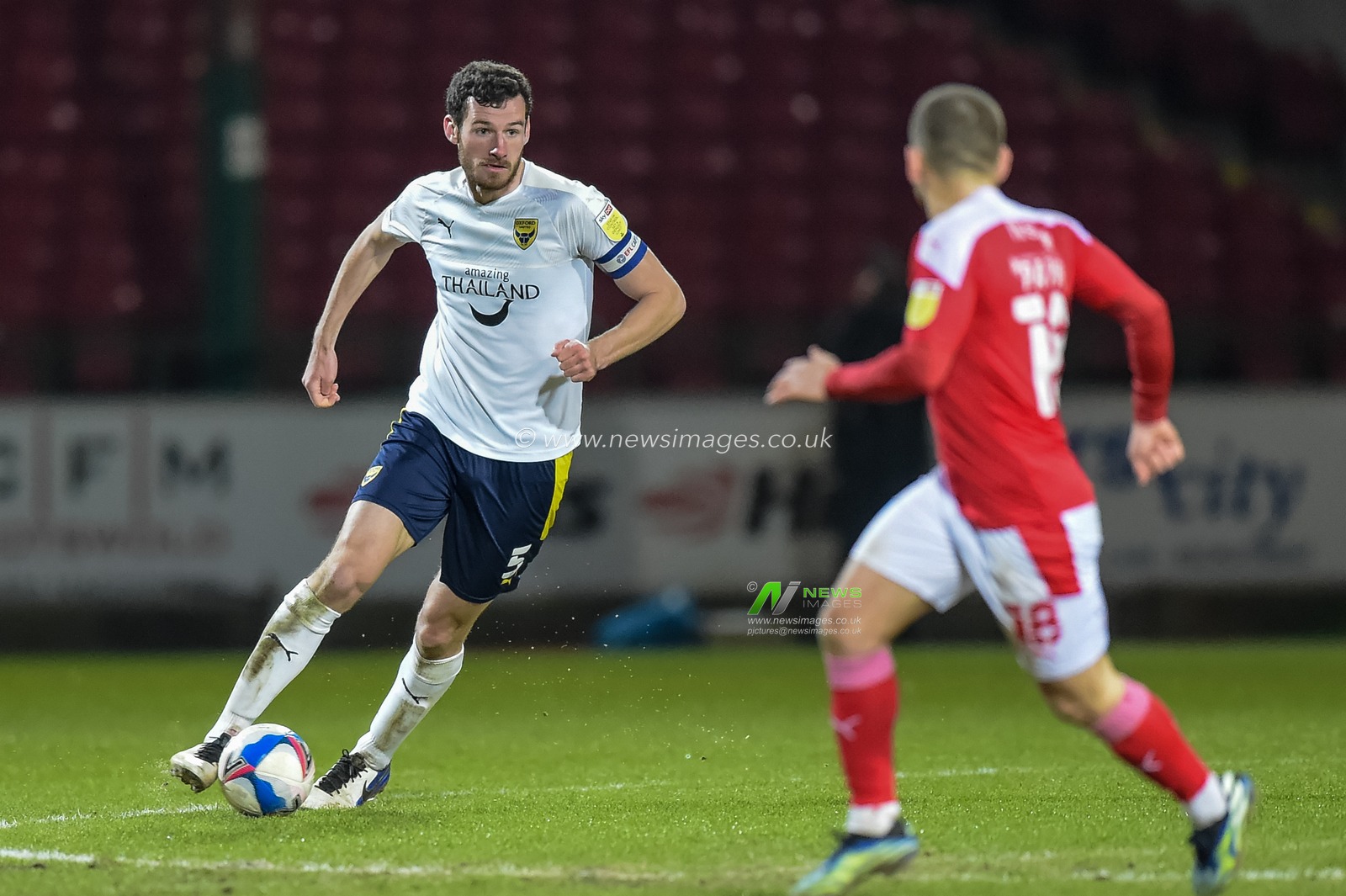 Elliott Moore #5 of Oxford United moves the ball forward