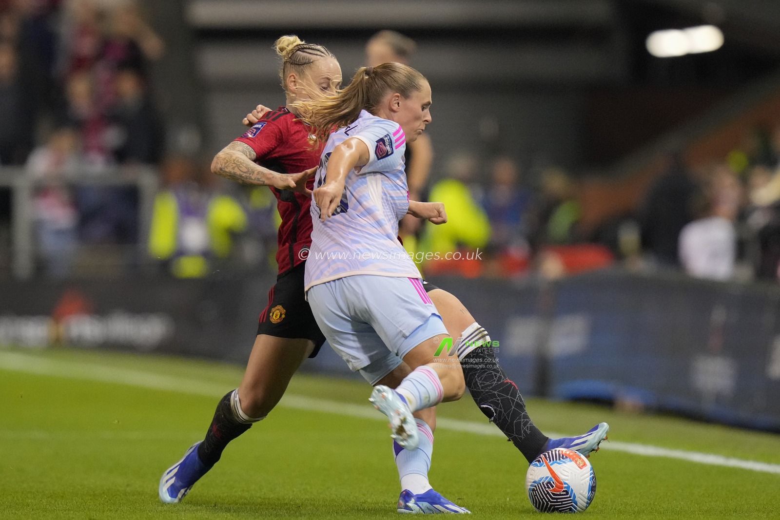 Leah Galton #11 of Manchester United challenges Kim Little #10 of Arsenal Women during the The FA Women's Super League match Manchester United Women vs Arsenal Women at Leigh Sports Village, Leigh, United Kingdom, 6th October 2023

(Photo by Steve Flynn/News Images)