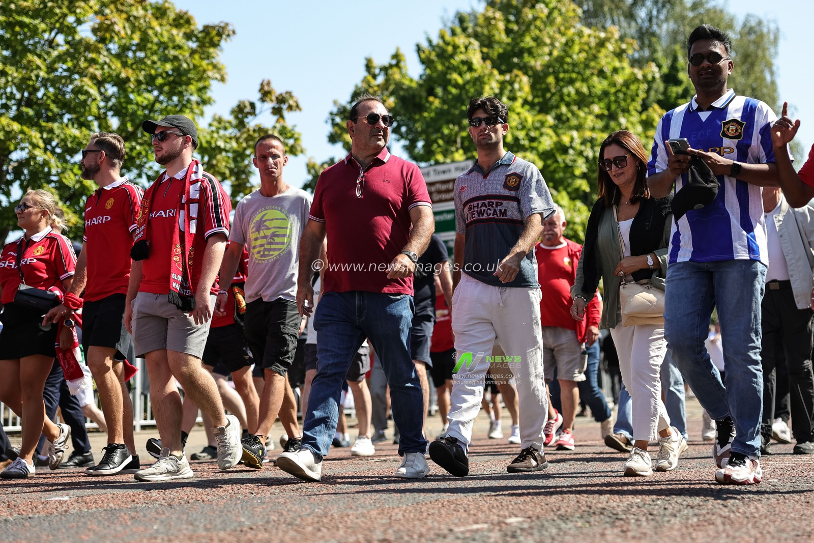 Manchester United fans make their way to Old Trafford during the Premier League match Manchester United vs Arsenal at Old Trafford, Manchester, United Kingdom, 17th August 2025

(Photo by Mark Cosgrove/News Images)