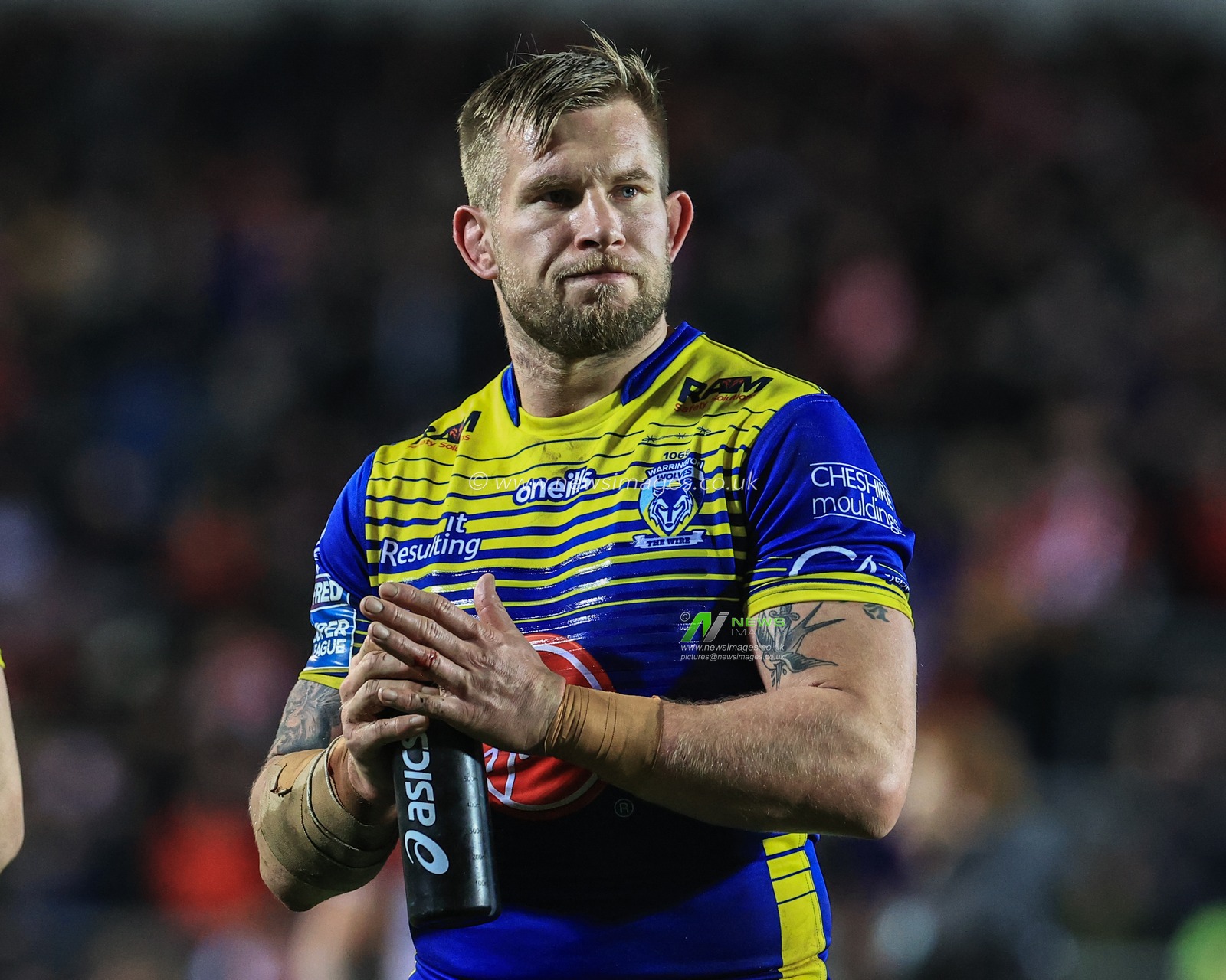 Mike Cooper #10 of Warrington Wolves applauds the traveling fans