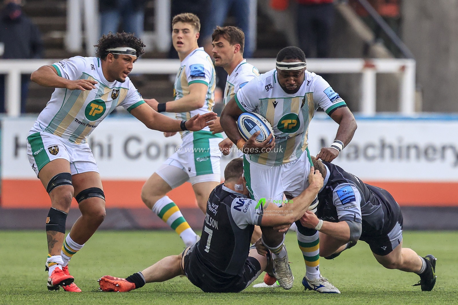 Api Ratuniyarawa of Northampton Saints is tackled by Mark Wilson of Newcastle Falcons and Adam Brocklebank of Newcastle Falcons