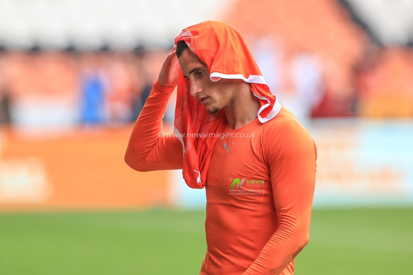 Jerry Yates #9 of Blackpool pops his shirt on his head as he makes his way back to the dressing room