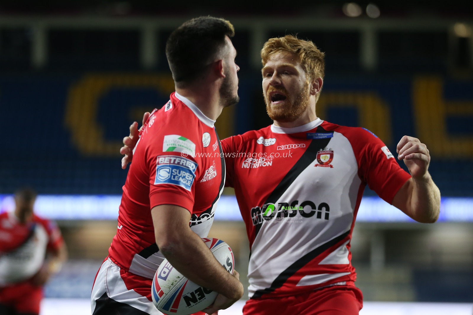 Niall Evalds (1) of Salford Red Devils celebrates scoring the 2nd try of the game with his team mates.