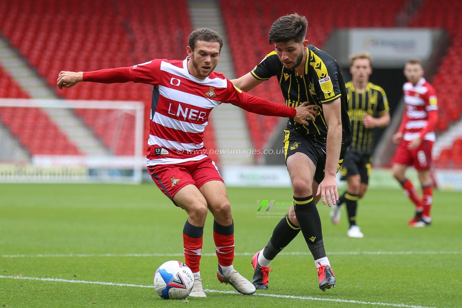Jon Taylor (11) of Doncaster Rovers looks to take on Cian Harries (25) of Bristol Rovers