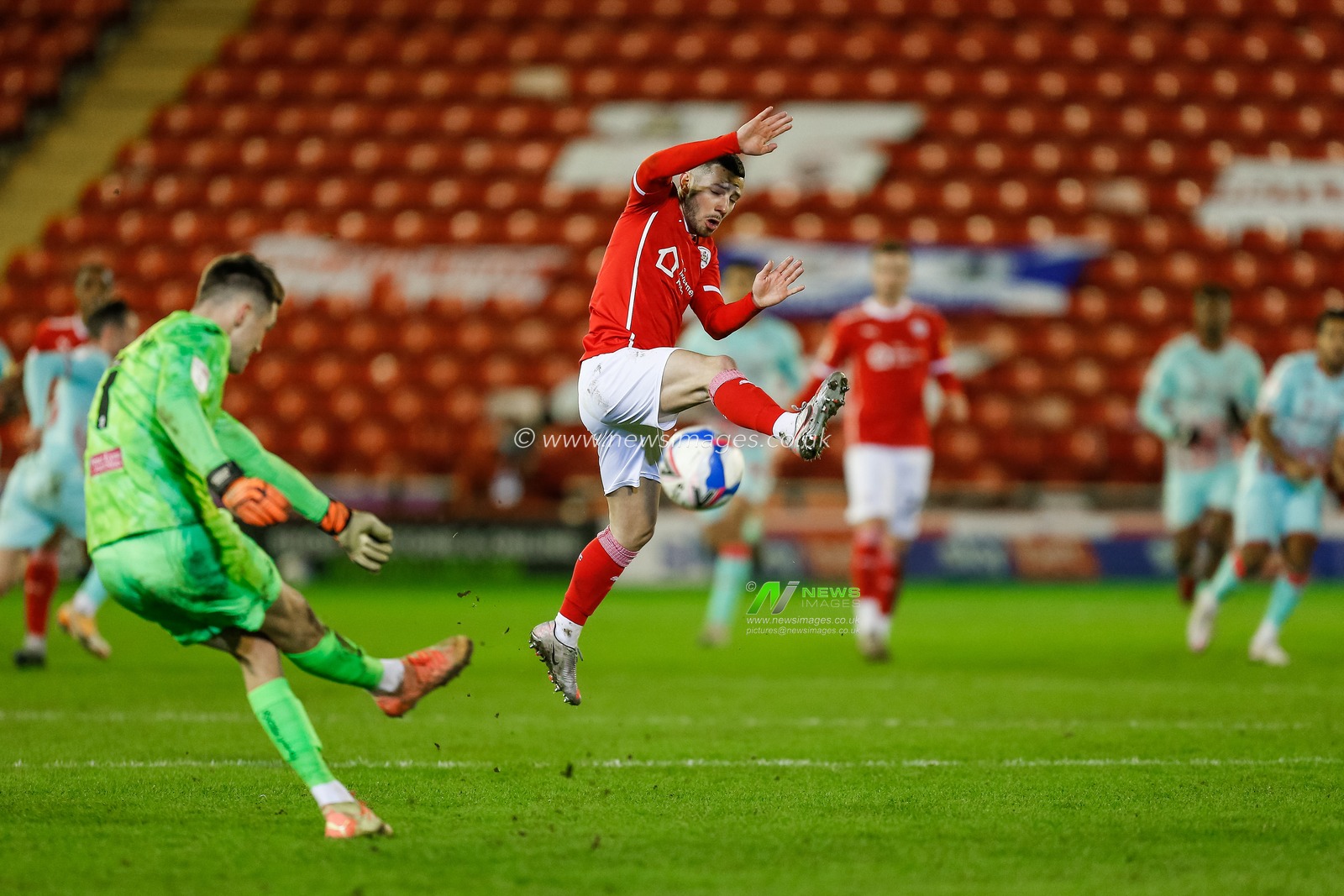 Freddie Woodman #1 of Swansea City kicks the ball towards Conor Chaplin #11 of Barnsley