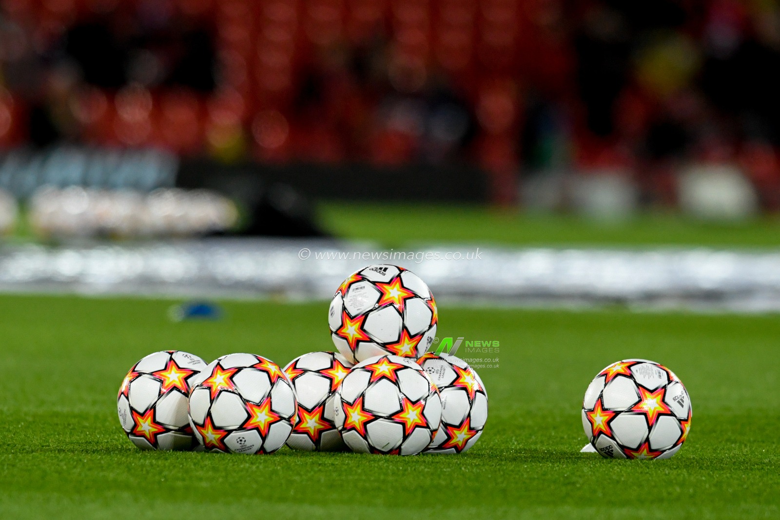The Adidas UEFA Champions League match balls on the pitch at Anfield