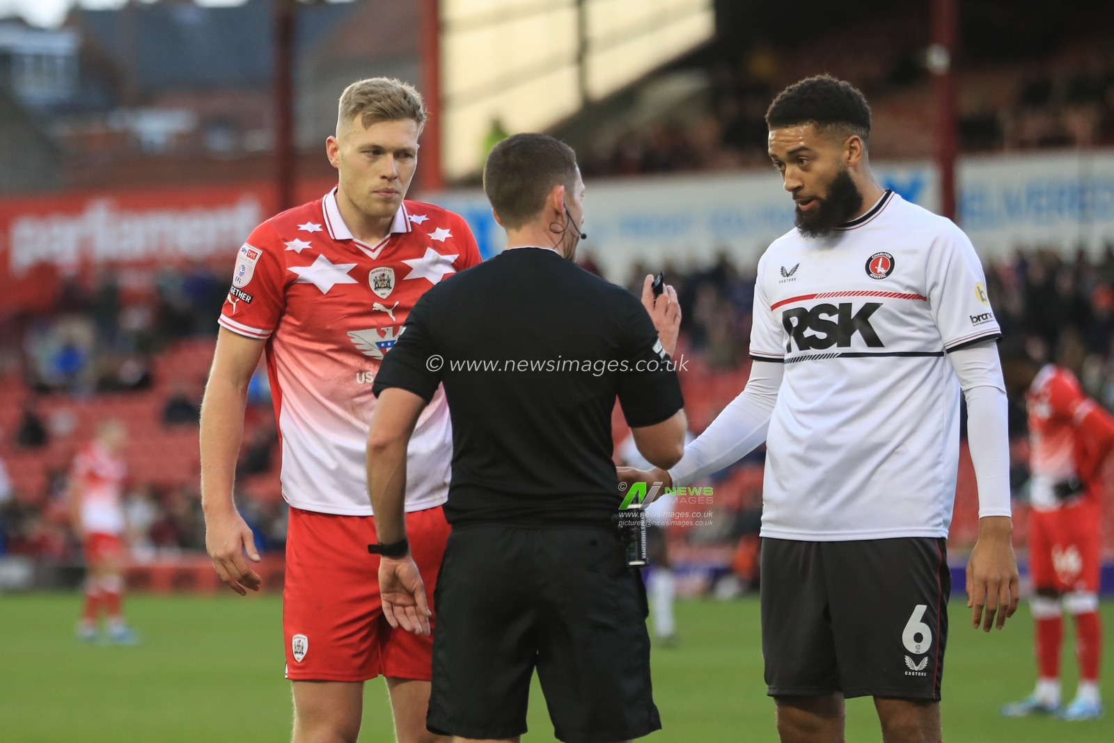 Referee Simon Mather speaks to Sam Cosgrove #9 of Barnsley and Michael Hector #6 of Charlton Athletic after Sam Cosgrove #9 of Barnsley goes down in the penalty area during the Sky Bet League 1 match Barnsley vs Charlton Athletic at Oakwell, Barnsley, United Kingdom, 16th December 2023

(Photo by Alfie Cosgrove/News Images)