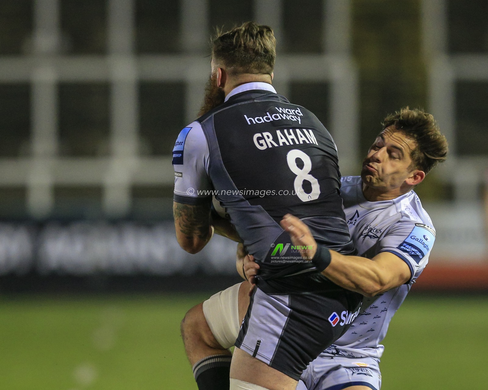 Rohan Janse van Rensburg of Sale Sharks tackles Gary Graham of Newcastle Falcons
