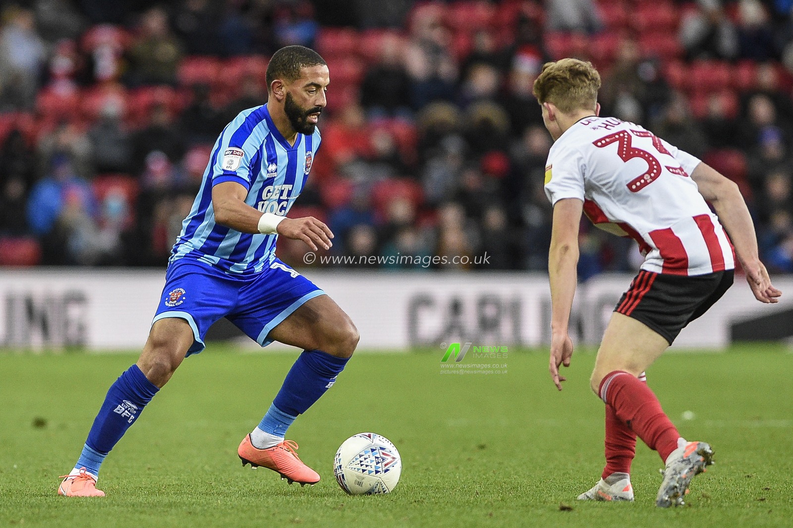 14th December 2019, Stadium Of Light, Sunderland, England; Sky Bet League 1, Sunderland v Blackpool : Liam Feeney (11) of Blackpool takes on Denver Hume (33) of Sunderland

Credit: Iam Burn/News Images