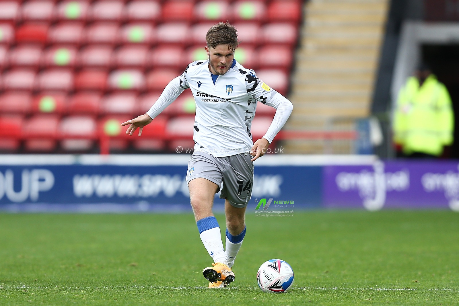Noah Chilvers (14) of Colchester United passes the ball