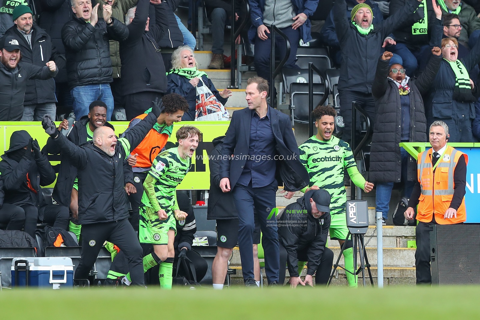 Forest Green Rovers players and coaches celebrate their teams win whilst Duncan Ferguson manager of Forest Green Rovers remains calm after the Sky Bet League 1 match Forest Green Rovers vs Sheffield Wednesday at The New Lawn, Nailsworth, United Kingdom, 26th March 2023

(Photo by Gareth Evans/News Images)