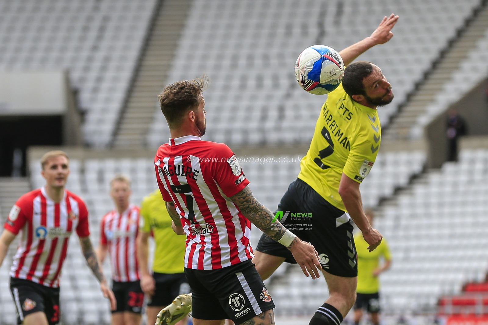 Michael Harriman #2 of Northampton Town heads the ball away from Chris Maguire #7 of Sunderland