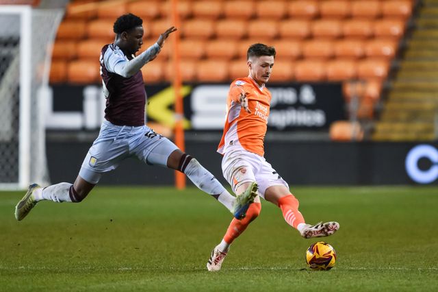 Zac Ashworth of Blackpool passes the ball despite pressure from Jamaldeen Jimoh-Aloba of Aston Villa during the The Vertu Trophy match Blackpool vs Aston Villa U21 at Bloomfield Road, Blackpool, United Kingdom, 17th December 2024

(Photo by Craig Thomas/News Images)