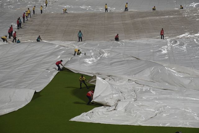 The ground staff work to keep the pitch dry as play is tries to stop the ball due to rain during the 2025 IPL match between Kolkata Knight Riders and Punjab Kings at Eden Gardens on April 26, 2025, in Kolkata, India. Photo by Debajyoti Chakraborty.(Photo: Debajyoti Chakraborty/News Images)