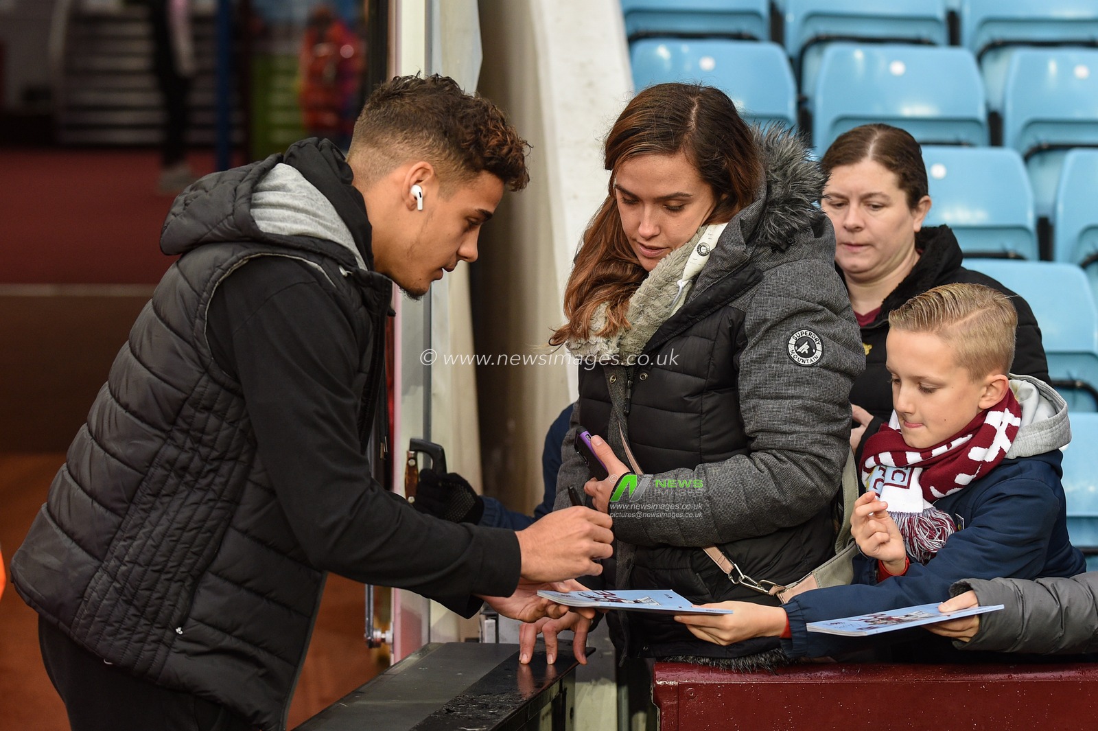 26th December 2019, Villa Park, Birmingham, England; Premier League, Aston Villa v Norwich City : Max Aarons (2) of Norwich City signs autographs at Villa Park

Credit: Richard Long/News Images