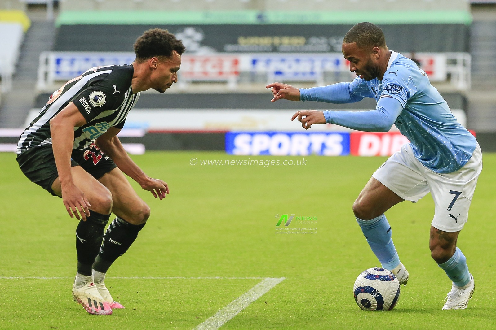 Raheem Sterling #7 of Manchester City takes on Jacob Murphy #23 of Newcastle United