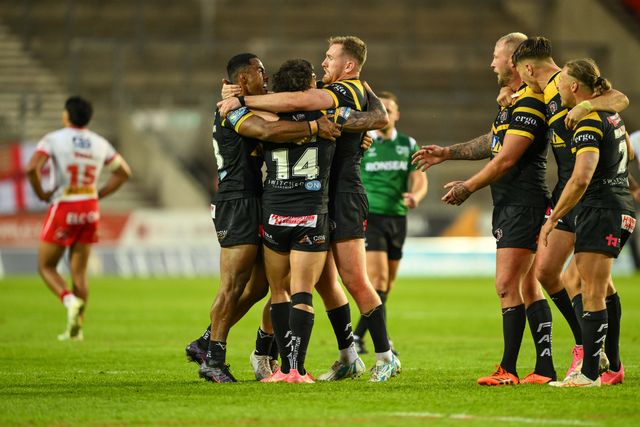 Liam Horne of Castleford Tigers  and Rowan Milnes of Castleford Tigers celebrate a famous win over St. Helens at the end of the Betfred Super League Round 16 match St Helens vs Castleford Tigers at Totally Wicked Stadium, St Helens, United Kingdom, 5th July 2024

(Photo by Craig Thomas/News Images)